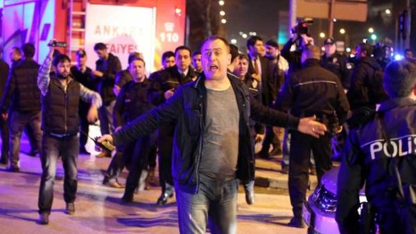 A man reacts next to policemen near the site of an explosion. (AFP/File)