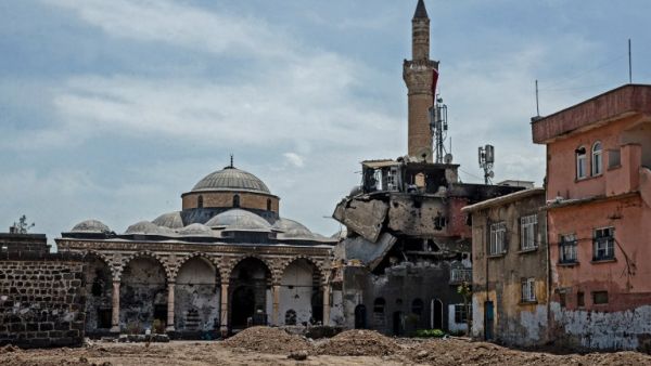 Damaged houses and a mosque are pictured in the historical district in Diyarbakir, southeastern Turkey, on May 5, 2016, following clashes between Turkish forces and Kurdish militants. (AFP/Ilyas Akengin)