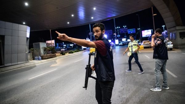 A Turkish police officer reacts at Ataturk airport`s main gate on June 28, 2016 in Istanbul after two explosions followed by gunfire hit Turkey's biggest airport. (AFP/Ozan Kose)