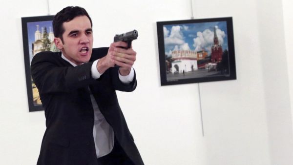 Photographer Burhan Ozbilici kept his cool and continued photographing as the ambassador was murdered, while others dove for cover. (Twitter/AP/Burhan Ozbilici)