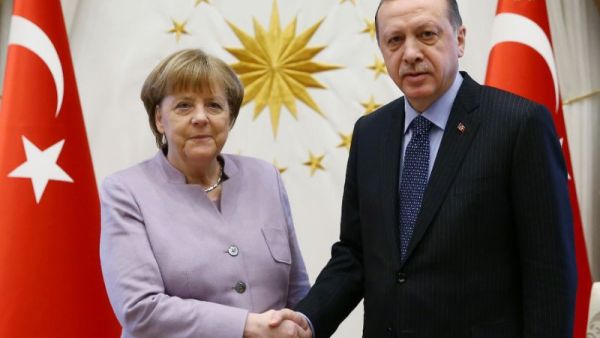 Turkish President Recep Tayyip Erdogan shakes hands with German Chancellor Angela Merkel in Ankara. (AFP Photo/KAYHAN OZER)