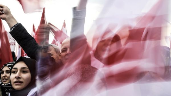 People wave "YES" banners and Turkish national flags on April 8, 2017 during a campaign rally for the "yes" vote in a constitutional referendum in Istanbul. (AFP/Bulent Kilic)