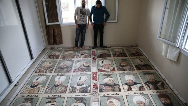 Abdulsettar al-Sattuf, right, is seen with his mosaic project depicting 36 Ottoman sultans. (Twitter/Anadolu)