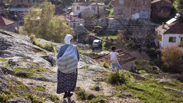 A Turkish woman and her grandson walk down the hill to their village near Bafa Lake. (Lindsey Leger)