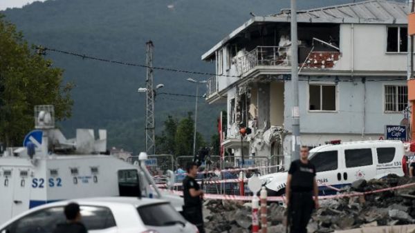Turkish police officers survey a bombed police station in Istanbul in 2015. (AFP/File)