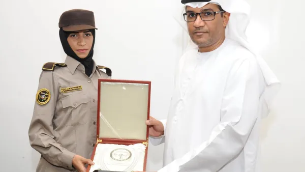 CEO of Himaya Security Colonel Ahmed Mohamed Al Hantoubi with a graduate of the first batch of female security guards at the National Security Institute in Abu Dhabi. (UAE Ministry of Interior)