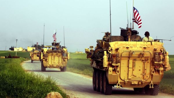 US forces, accompanied by Kurdish People's Protection Units (YPG) fighters, drive their armoured vehicles near the northern Syrian village of Darbasiyah. (AFP/File)