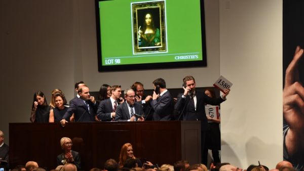 Christie's employees take bids for Leonardo da Vinci’s "Salvator Mundi" at Christie's New York November 15, 2017 (Timothy A. Clary/AFP)