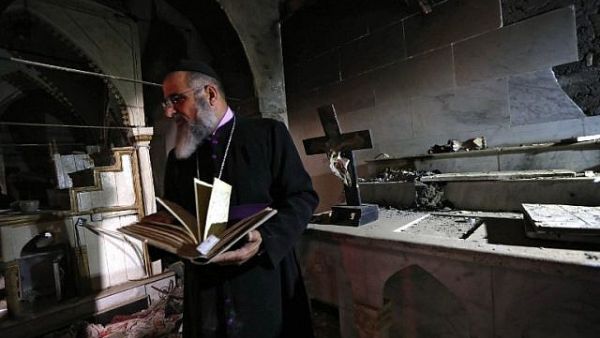 David Dosha, the priest of the Church of Mart Shmony, located in the Christian Iraqi town of Bartalla, about 15 kilometers (10 miles) east of Mosul. (AFP)
