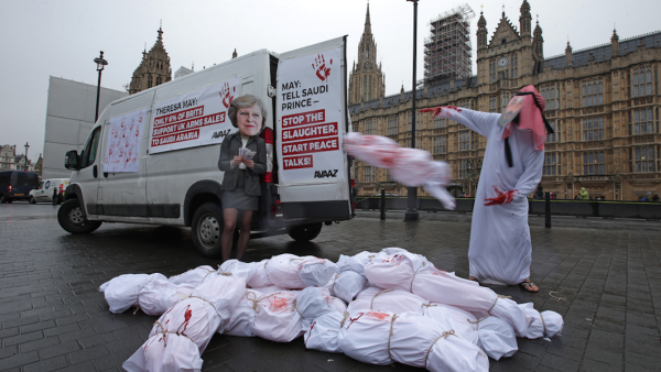 Demonstrators wearing masks depicting Britain's Prime Minister Theresa May (L) and Saudi Arabia's Crown Prince Mohammed bin Salman protest outside of the Houses of Parliament in London on March 7, 2018, against the visit to the U.K. by the Crown Prince. (Daniel Leal-Olivas / AFP) 