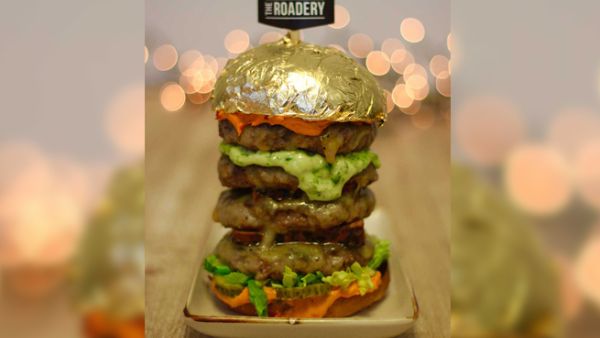 The towering burger is topped with edible 24-carat gold. (Courtesy The Roadery)