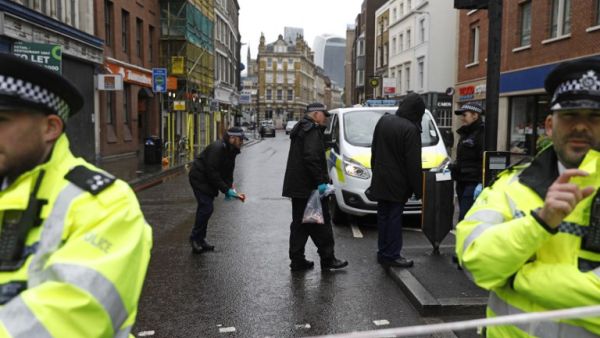 Police officers work on Borough High Street, close to Borough Market, in London on June 6, 2017, as the police investigations continue following the June 3 terror attack. (Odd Andersen/AFP)