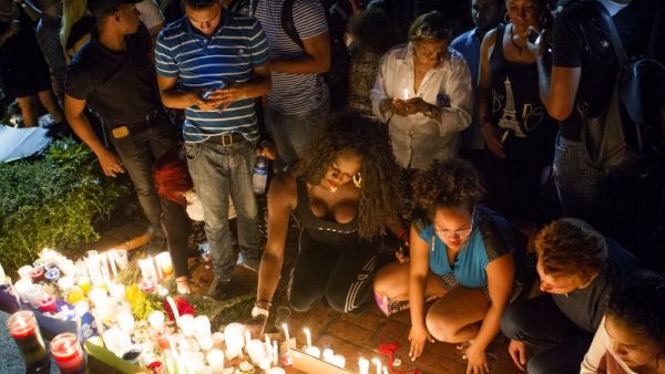 People light candles at a memorial gathering for those killed in Orlando at the Colonial Zone in Santo Domingo on June 14, 2016. (AFP/Erika Santelices)