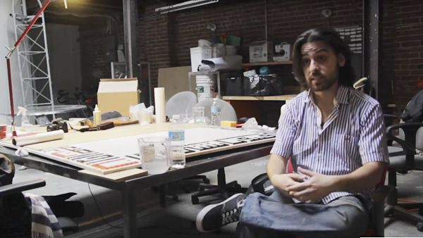 Ramsey Nasser with one of his calligraphy pieces created by Alb, an Arabic computer programming language he designed. (YouTube/Animal New York)