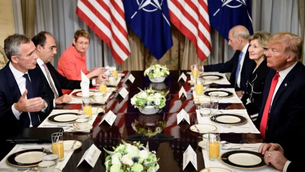 NATO Secretary General Jens Stoltenberg (L) and US President Donald Trump (R) and staff speak at a breakfast meeting at the US chief of mission's residence in Brussels on July 11, 2018, ahead of a NATO summit. (Brendan Smialowski/ AFP)

