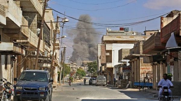 smoke rising as government forces target the city, 4 kilometers east of Khan Shaykhun in the southern countryside of Idlib province. (AFP/ File)