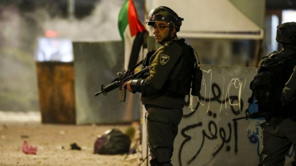 An Israeli border guard stands during clashes with Palestinian protesters in the occupied West Bank city of Ramallah on December 11, 2018. (AFP)
