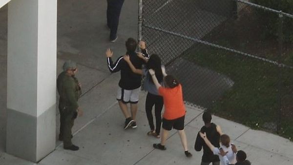 People are brought out of the Marjory Stoneman Douglas High School after a shooting at the school that reportedly killed and injured multiple people on February 14, 2018 in Parkland, Florida. (AFP/ File Photo)