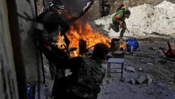 Syrian rebels of the Halab al-Shabah battalion under Al-Tawhid brigade take position during clashes with regime forces in Al-Amariya district of the northern city of Aleppo. (AFP/File)

