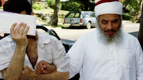 This file photo taken on June 25, 1993 shows Sheikh Omar Abdel-Rahman (R) entering his apartment building with an unidentified man after afternoon prayers at his mosque in Jersey City, New Jersey. (AFP/Mark D. Phillips)