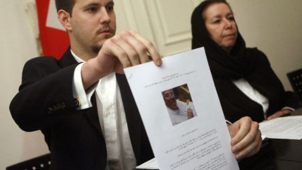 Daniel Levinson (L) shows a picture of his missing father, ex-FBI agent Robert Levinson, during a press conference at the Swiss embassy in Tehran, Iran, on December 22, 2007 (AFP/Behrouz Mehri)
