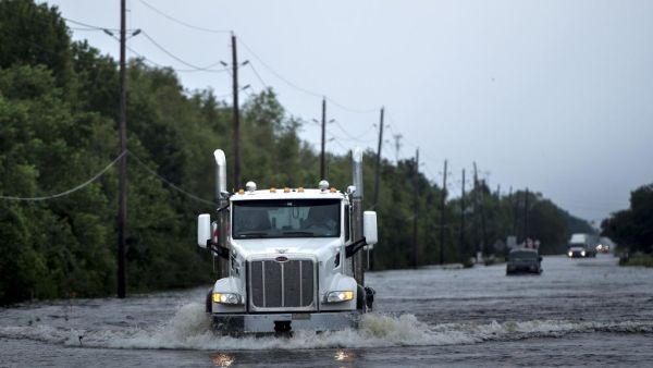 A driver on an Oregon road captured video of a semi truck that somehow lost two wheels on a city road. (AFP/ File Photo)