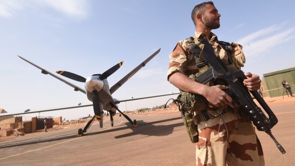 A French soldier of the aerial detachment of the Operation Barkhane stands guard near a Reaper drone at the Nigerian military airport Diori Hamani in Niamey. (AFP)
