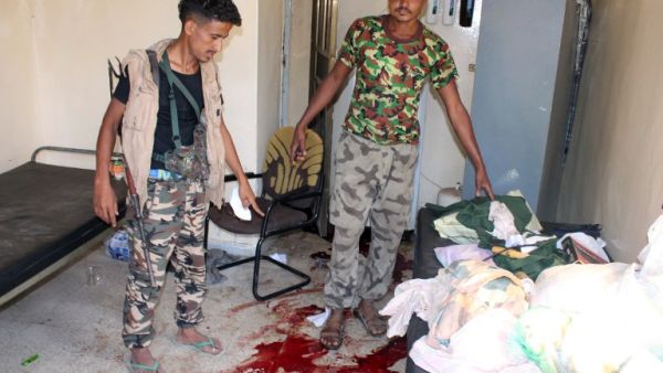Loyalist forces to embattled President Hadi examine the aftermath of the attack on an elderly care home in Aden. (AFP/Saleh Al-Obeidi)