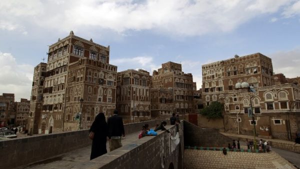 Residents walk toward the old city of Yemen's capital, Sanaa. (AFP/Mohammed Huwais)