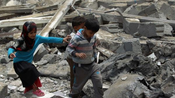 Yemeni children walk through rubble after an airstrike in the Houthi-held Sanaa, capital of Yemen. (AFP/Mohammed Huwais)