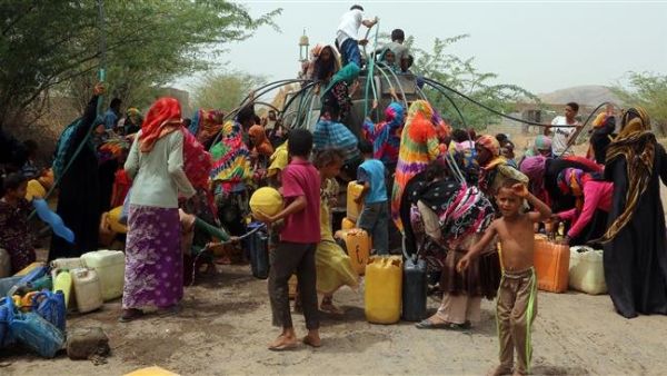 Yemenis gather next to a water tank to collect water in an impoverished coastal village on the outskirts of the Yemeni port city of Hudaydah, on May 12, 2018. (AFP)