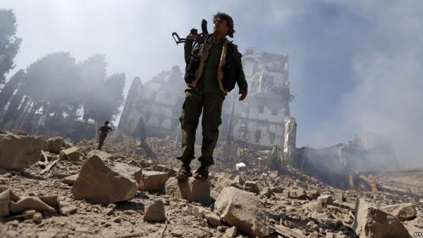Houthi rebel fighters inspect the damage after a reported airstrike carried out by the Saudi-led coalition targeted the presidential palace in the Yemeni capital Sana'a. (AFP/ File)
