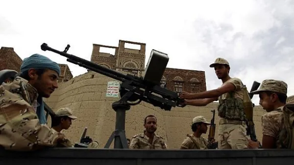 Armed Houthi rebels ride in the back of a truck during a rally in the capital Sanaa. (AFP/Mohammed Huwais)