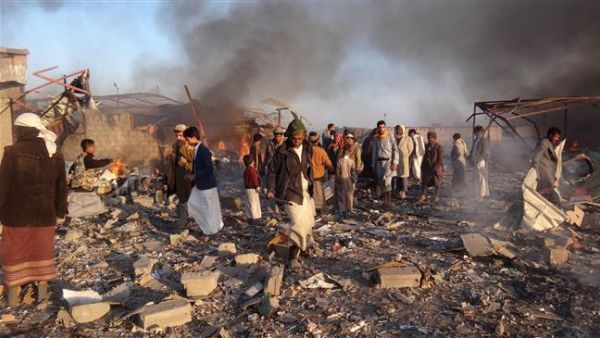 Smoke rises as Yemenis inspect the damage at the site of Saudi-led airstrikes in the northwestern city of Sa’ada, Yemen