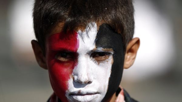 A Yemeni child, with his face painted in the colours of his national flag, looks on during an anti-US protest staged by supporters of the Huthi rebels in Sanaa on May 20, 2017. (Mohammed Huwais/AFP)