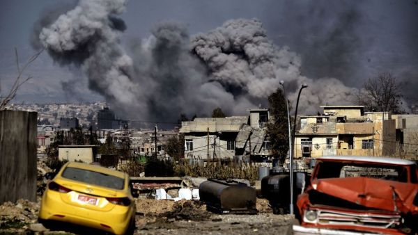 Smoke plumes rise after an airstrike in west Mosul on March 10, 2017 as Iraqi forces advance in the city during the ongoing battle to seize it from the jihadists of the Islamic State (IS) group. / AFP PHOTO / ARIS MESSINIS (ARIS MESSINIS/AFP) 