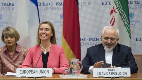 Iranian Foreign Minister Mohammad Javad Zarif speaks next to European Union High Representative for Foreign Affairs and Security Policy Federica Mogherini during a plenary session at the United Nations building in Vienna, Austria on July 14, 2015 (AFP)