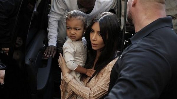 Kim Kardashian and Kanye West are expecting their third child via surrogate after the holidays. (AFP/File)