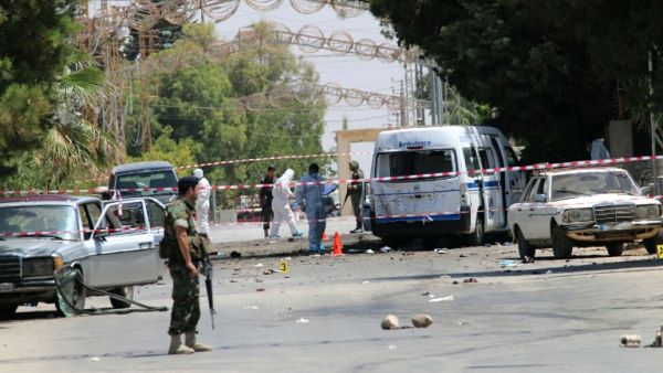 Lebanese security forces marked off the site of Monday morning's suicide bombings in al-Qaa, less than 24 hours before three more suicide bombings hit the town. (AFP/Stringer)