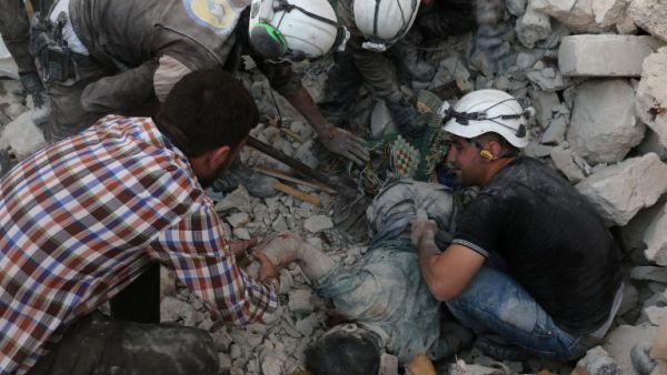 Syrian civil defence volunteers remove the body of a man from the rubble of destroyed buildings following reported airstrikes on April 27, 2016 in the rebel-held eastern neighbourhood of Bab al-Nayrab in the city of Aleppo. (AFP/Ameer al-Halbi)