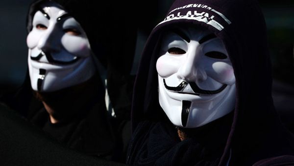 Illustrative photo of hacktivists in masks. (AFP/Aris Messinis)