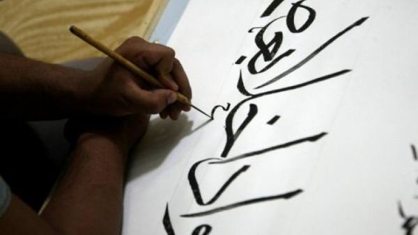 Iraqi calligrapher Hussein al-Kharsan writes verses from the Quran, Islam's holy book, in the Shiite holy city of Najaf. (AFP/Qassem Zein)