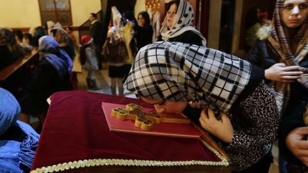Assyrian Christians from Iraq, Syria and Lebanon arrive to attend a Christmas mass at Saint Georges church in an eastern Beirut suburb. (AFP/Ahmad al-Rubaye)