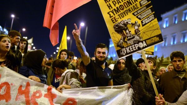 A Syrian man flashes a victory sign during a demonstration by in Greece stranded refugees and supporting groups in Athens on March 30, 2016. (AFP/Louisa Gouliamaki)