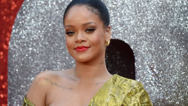 Rihanna did her best to keep the garment in place as she strutted along to the eatery. (Source:ANTHONY HARVEY / AFP) 