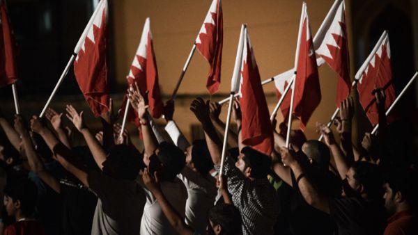 Protesters wave Bahraini flags. (AFP/File)