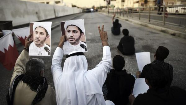 Bahraini protesters hold signs of Sheikh Salman, the leader of the Shia opposition group in Bahrain. (Al Bawaba/File)