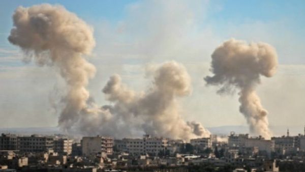 Smoke rises from buildings following bombardment  in the rebel-held besieged Eastern Ghouta (AFP/File Photo)
