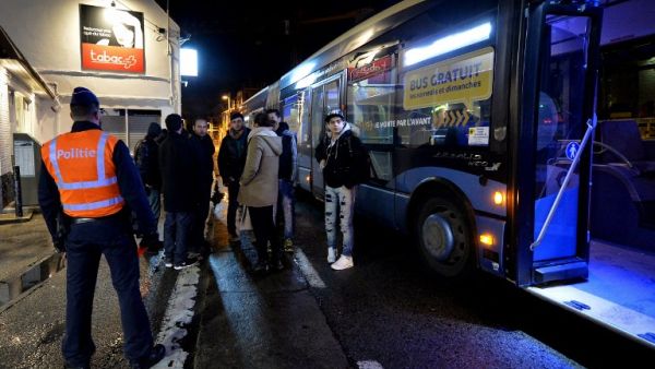Passengers on the way from France to Belgium stand outside during a police border control in Adinkerke on February 23, 2016 as Belgium announced it would reinstate border controls fearing an influx of migrants. (AFP/David Stockman)
