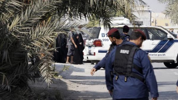 Bahraini police stand near the site of a bomb blast in a village south of Manama, on Dec. 9, 2014. (AFP/Mohammed al-Shaikh)